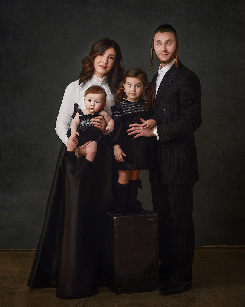 glamour full length family portrait of jewish family wearing black and white stylish clothing