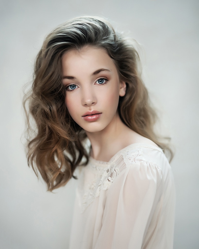fine art portrait of a beautiful girl in a cream top