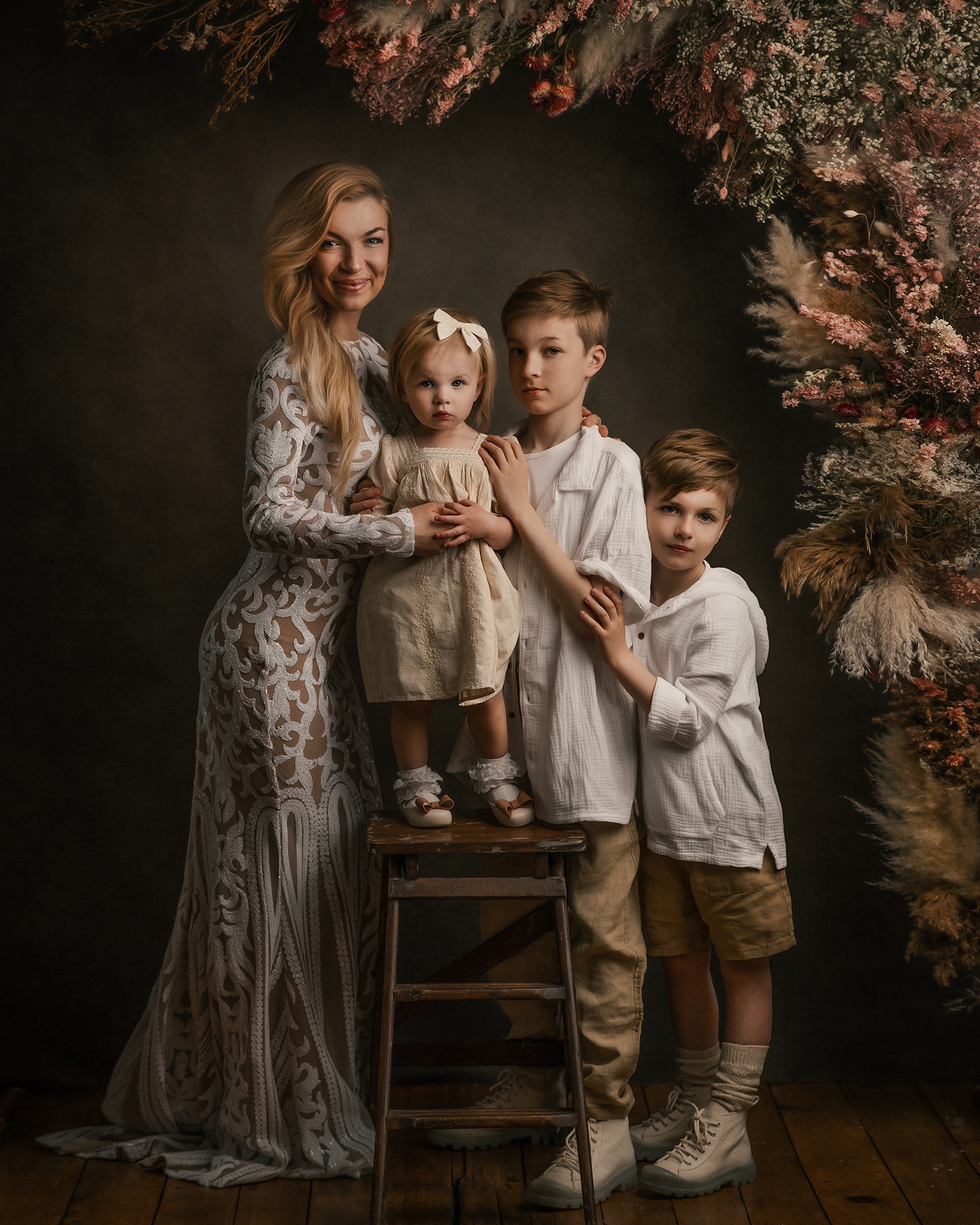 boho style family photoshoot, mom and kids wearing white boho clothing, flower arch