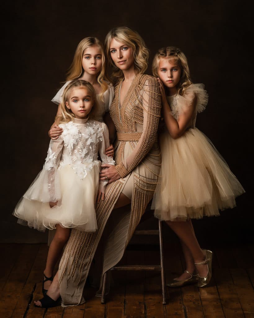 Mother with three blond daughters during glamorous studio photoshoot in Kettering Northamptonshire